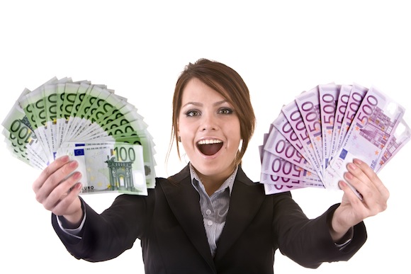 Businesswomen with group of money.